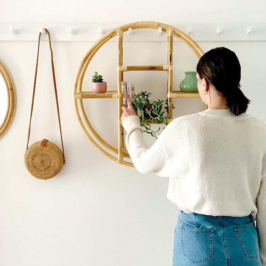 girl standing in front of the wall shelves