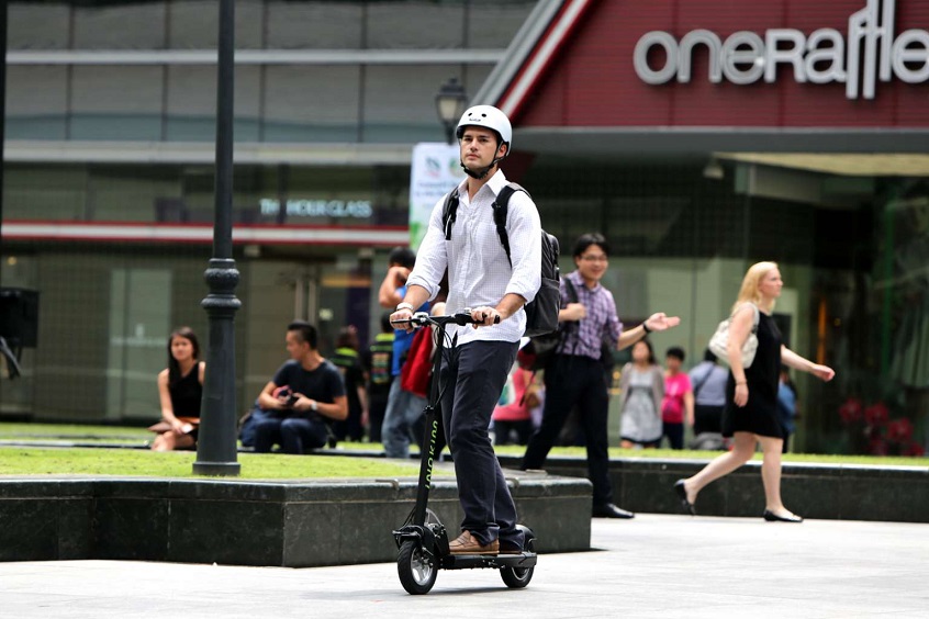 ridding scooter with helmet