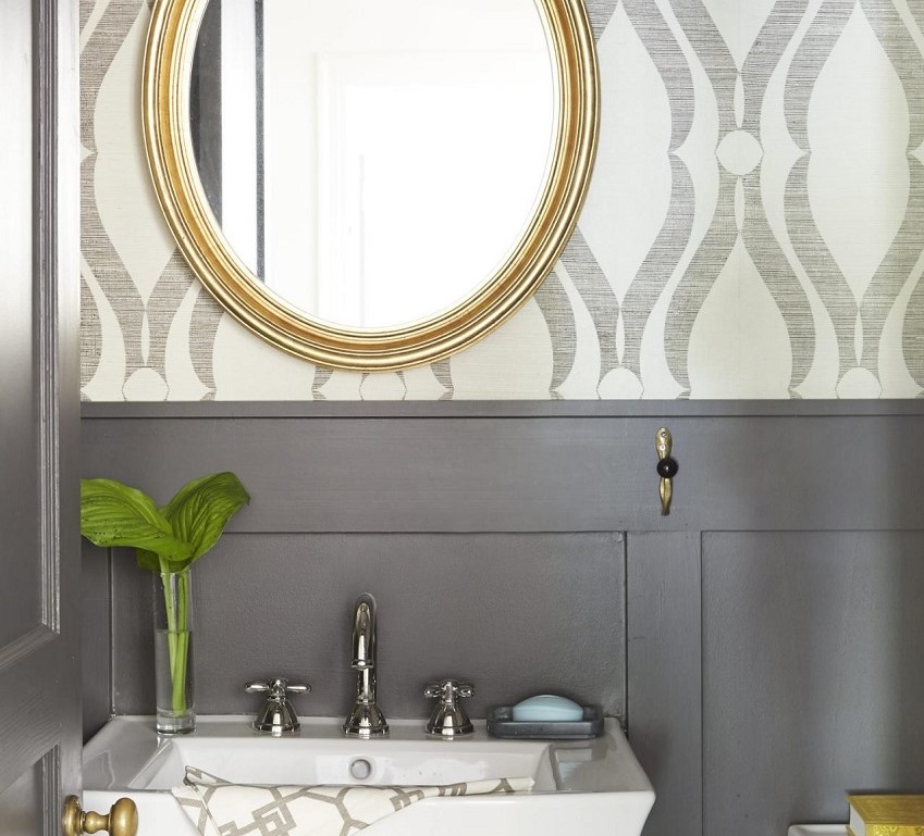 patterned wallpaper in bathroom with gold mirror 