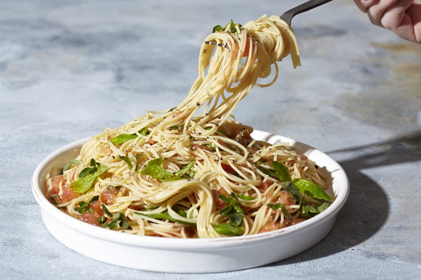 fork twirling gluten free pasta with basil