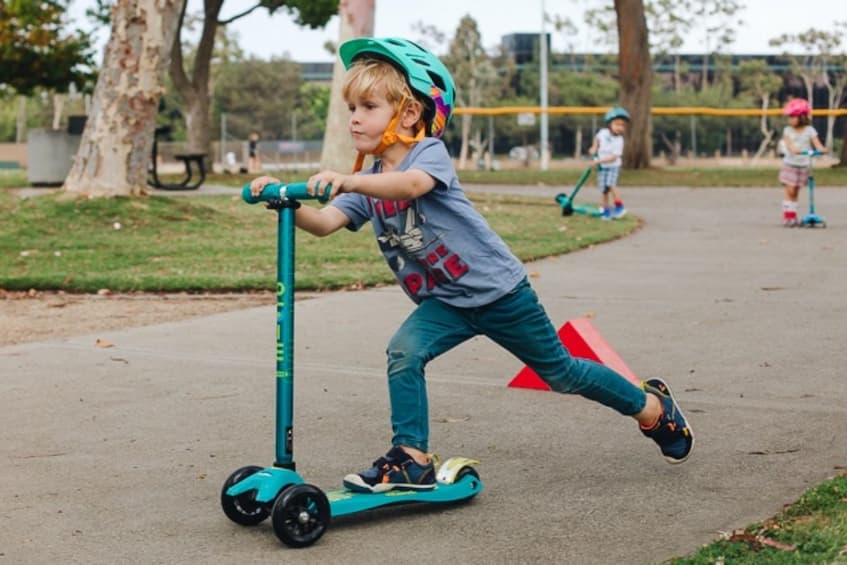 kid on a blue scooter